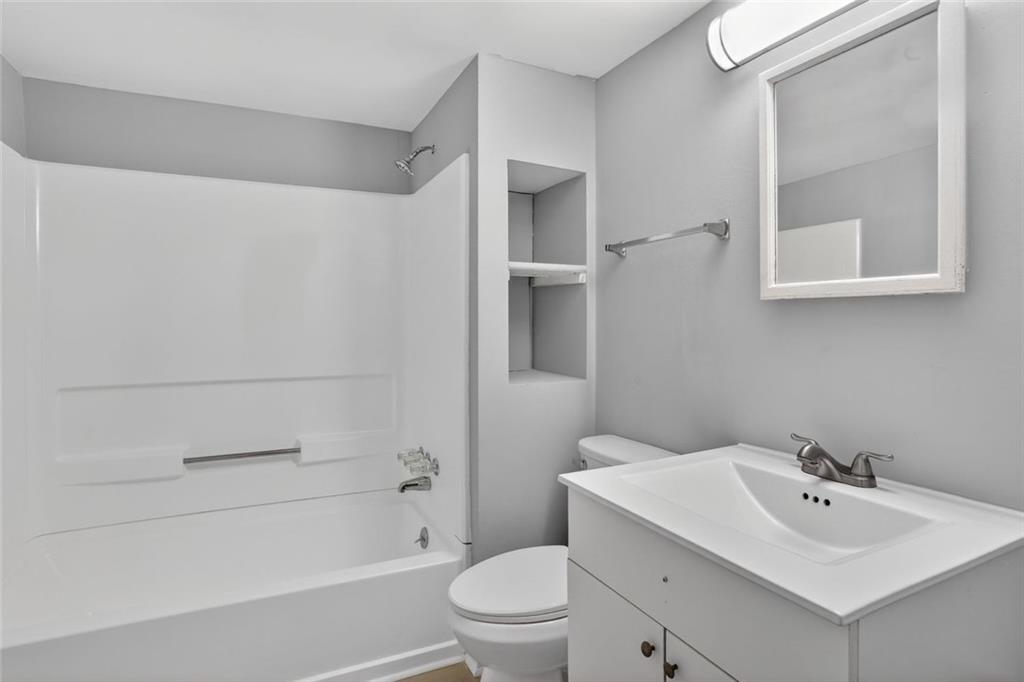 2728 Winburn Terrace Atlanta, GA 30344 - Photo 13 of 16 a bathroom with a sink toilet and shower