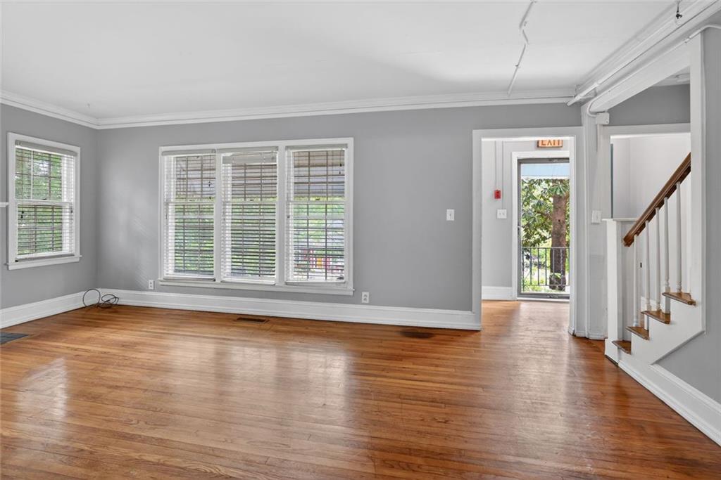 2728 Winburn Terrace Atlanta, GA 30344 - Photo 2 of 16 a view of an empty room with wooden floor and a window