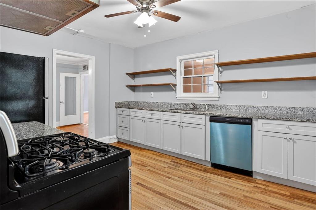 2728 Winburn Terrace Atlanta, GA 30344 - Photo 5 of 16 a kitchen with granite countertop stainless steel appliances sink cabinets and wooden floor