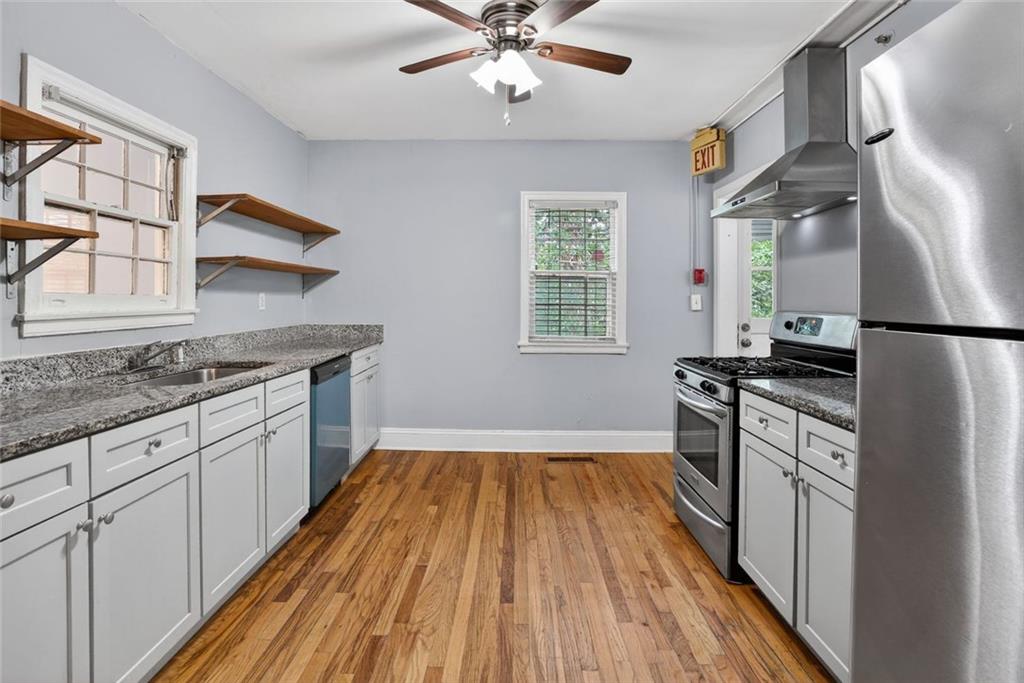 2728 Winburn Terrace Atlanta, GA 30344 - Photo 6 of 16 a kitchen with a sink appliances wooden floor and a window