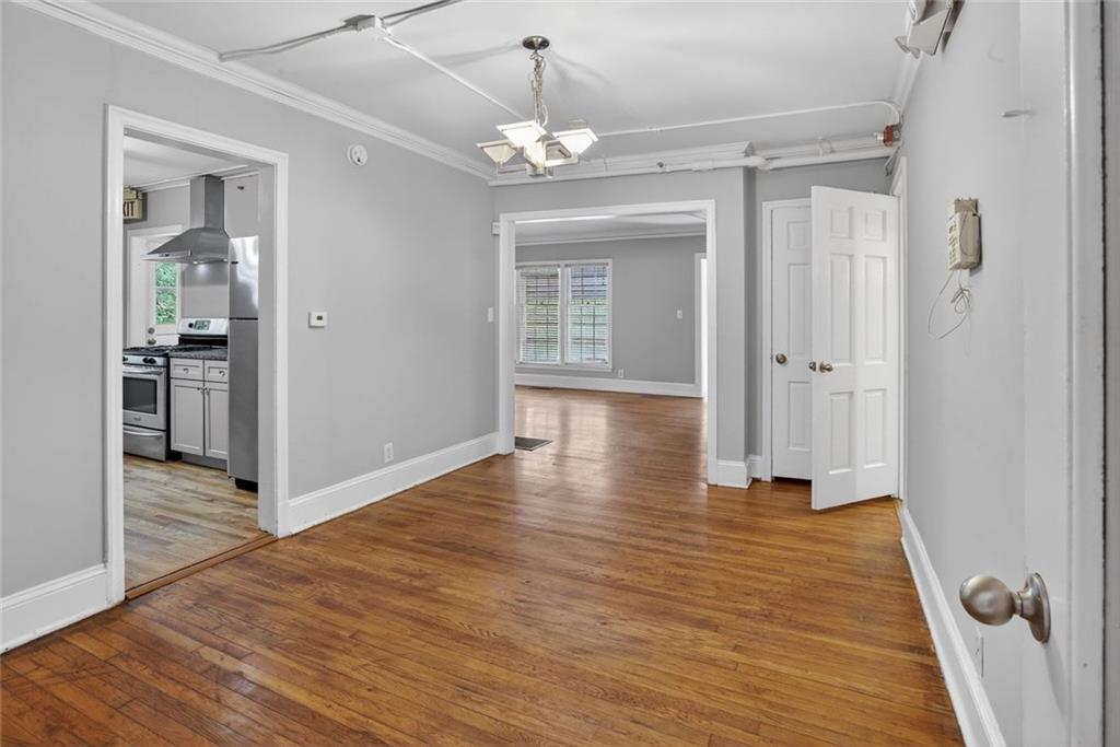 2728 Winburn Terrace Atlanta, GA 30344 - Photo 7 of 16 a view of a hallway with wooden floor and a chandelier