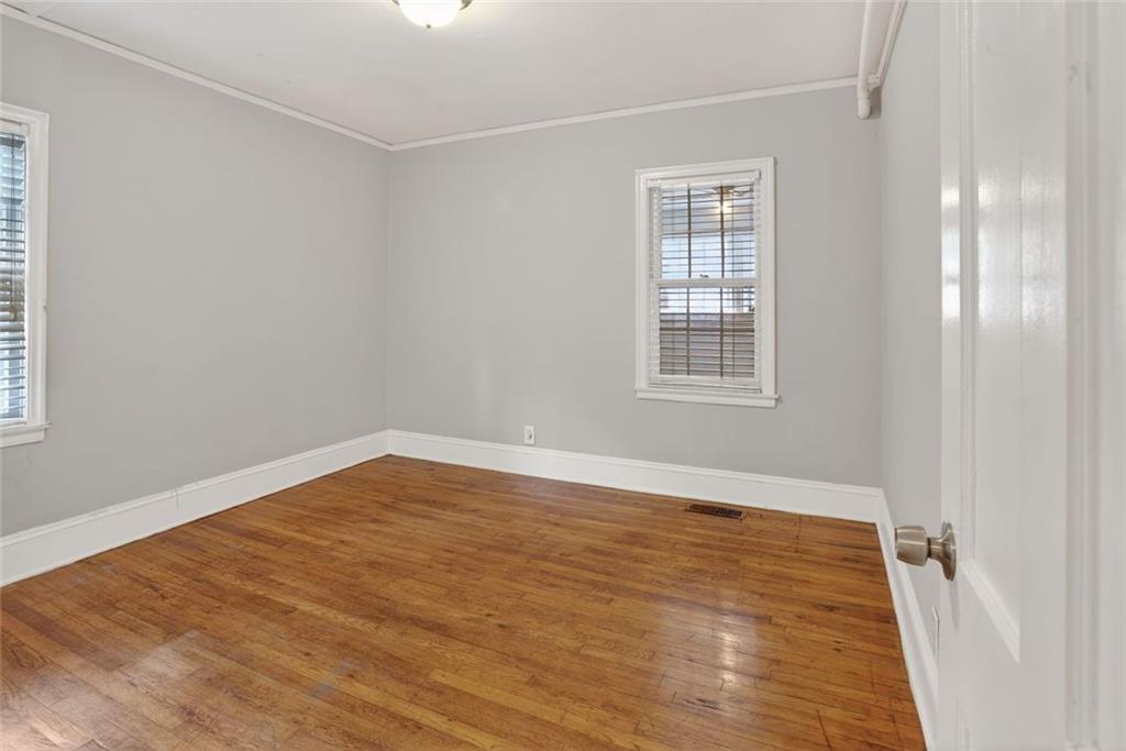 2728 Winburn Terrace Atlanta, GA 30344 - Photo 8 of 16 a view of an empty room with wooden floor and a window