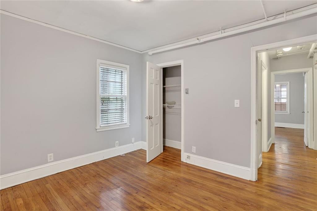 2728 Winburn Terrace Atlanta, GA 30344 - Photo 10 of 16 an empty room with wooden floor and windows