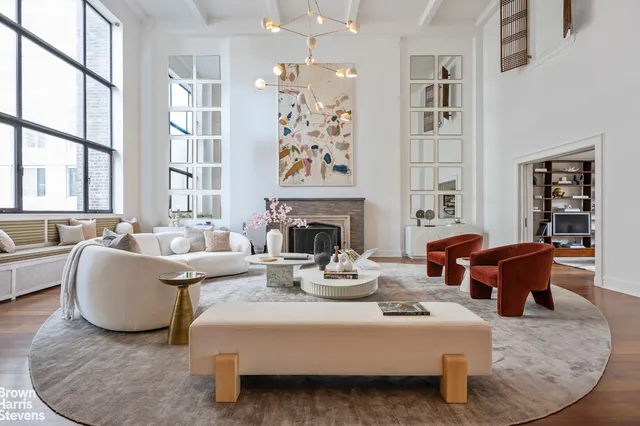 a living room with fireplace furniture and a large window