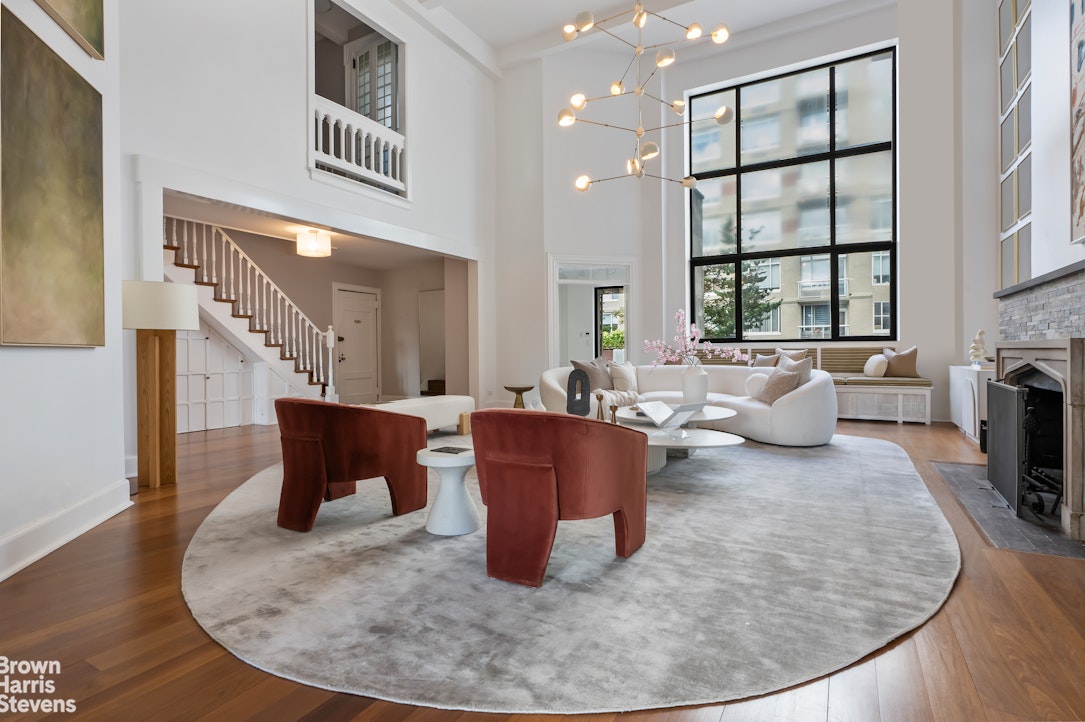 257 West 86th Street, Unit PHA Manhattan, NY 10024 - Photo 3 of 17 a living room with furniture and a fireplace