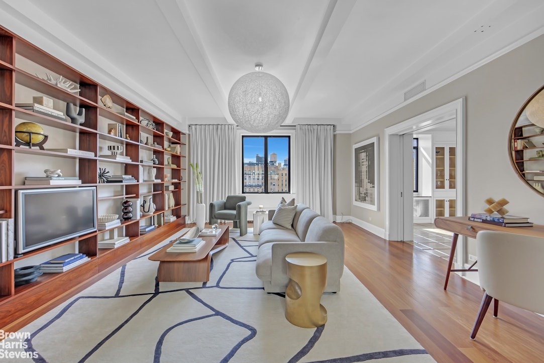 257 West 86th Street, Unit PHA Manhattan, NY 10024 - Photo 7 of 17 a living room with fireplace furniture and a flat screen tv