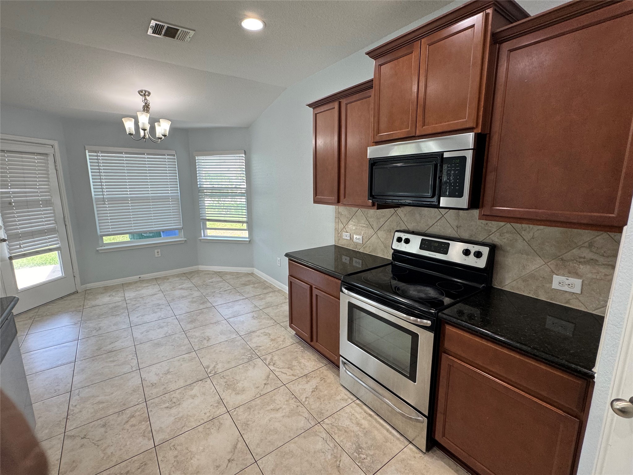 1520 Portchester Castle Path Pflugerville, TX 78660 - Photo 5 of 26 A well-appointed kitchen featuring sleek appliances and abundant natural light.