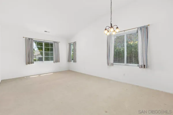 a kitchen with stainless steel appliances granite countertop a refrigerator a sink a stove and a refrigerator