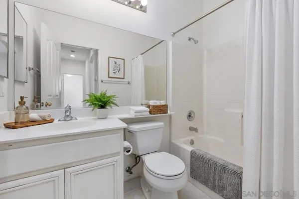 a bathroom with a sink toilet a mirror and shower