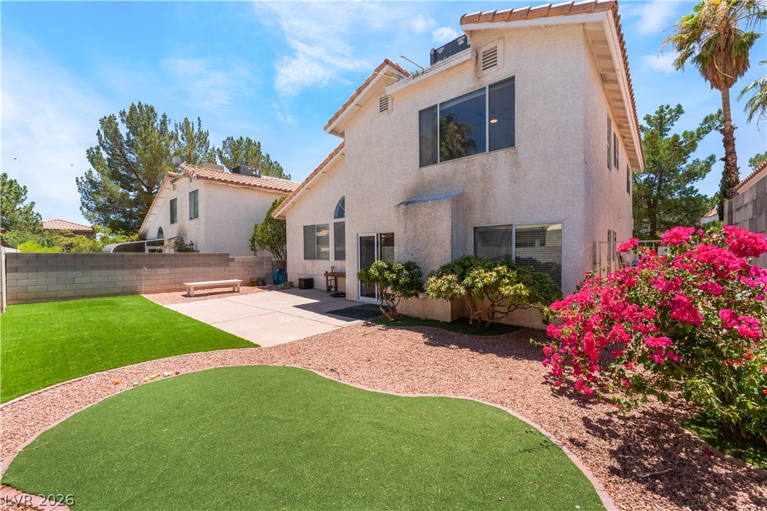 8872 Chapman Point Las Vegas, NV 89129 - Photo 23 of 29 A private, low-maintenance yard offers both paved patio and artificial turf areas, perfect for desert living.