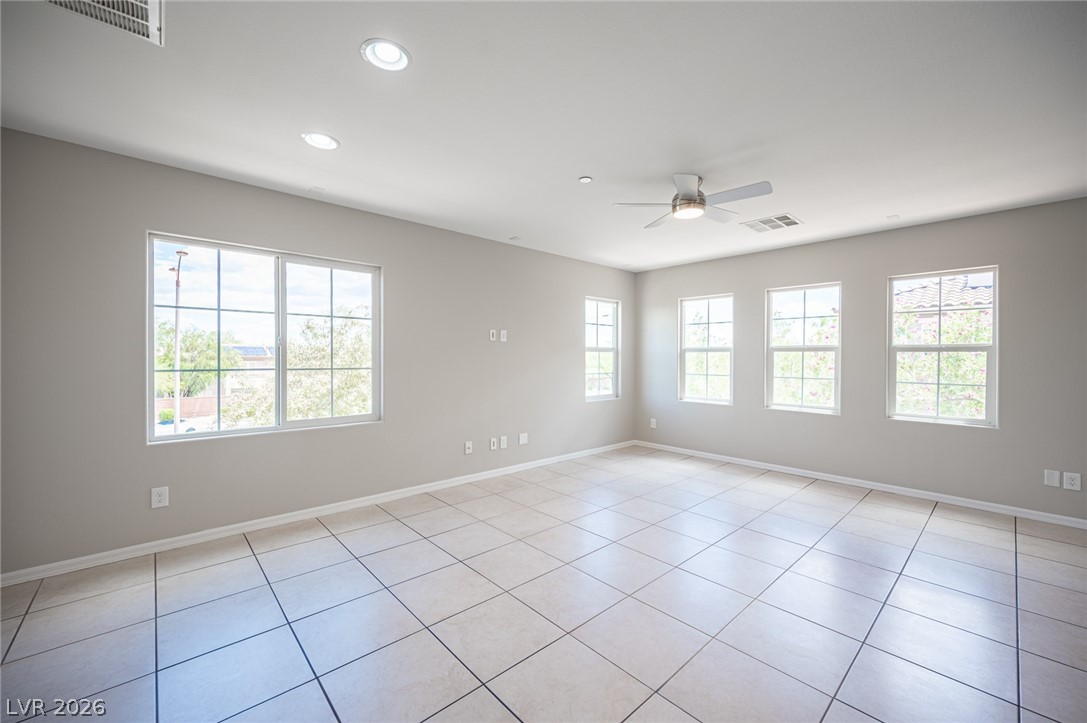 9916 Sable Point Street Las Vegas, NV 89178 - Photo 26 of 73 A generously sized living space featuring neutral tones and ample natural light from multiple windows.