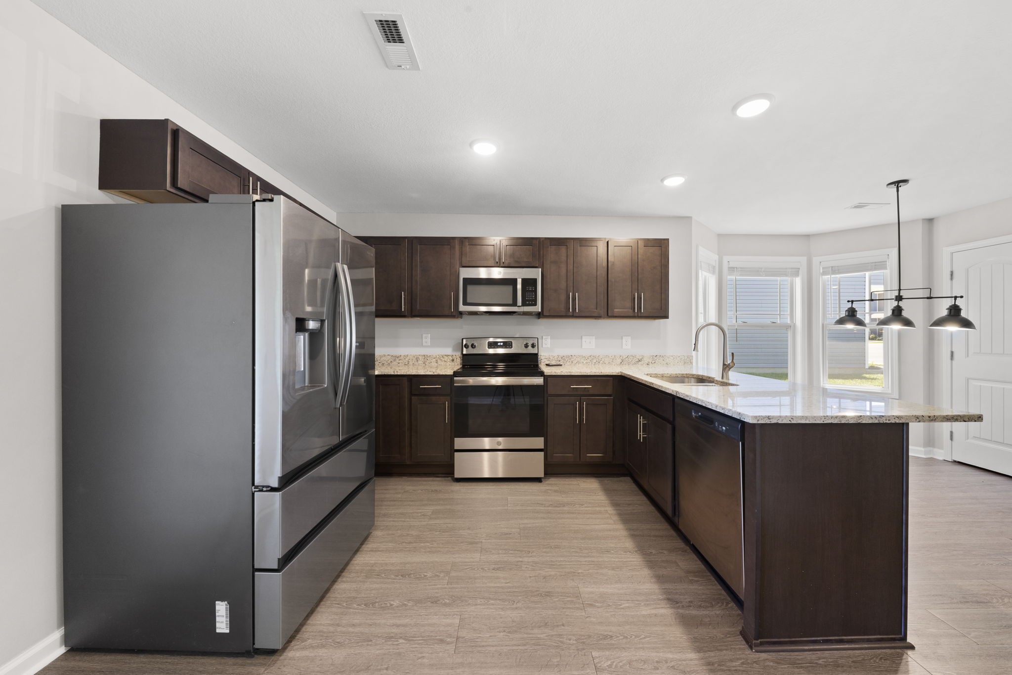 119 Davis Ridge Lane Clarksville, TN 37040 - Photo 12 of 30 a large kitchen with stainless steel appliances kitchen island granite countertop a refrigerator and a sink