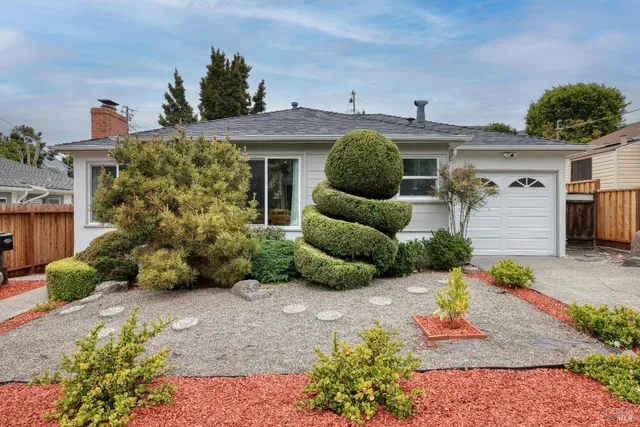 a front view of a house with garden