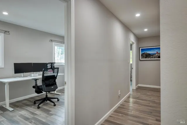 a view of a workspace with furniture and a window