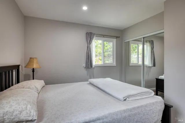 a living room with furniture a flat screen tv and a window
