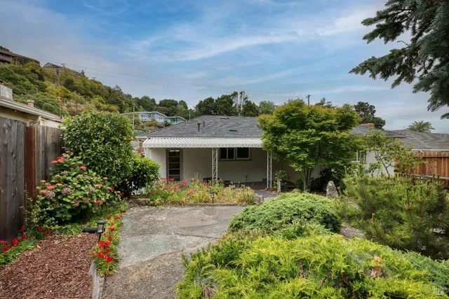 a backyard of a house with a yard and outdoor seating