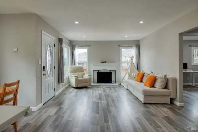 a living room with furniture and a fireplace