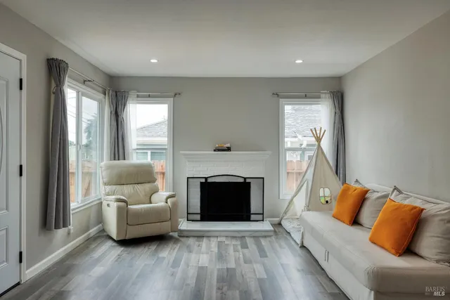 a living room with furniture and a fireplace