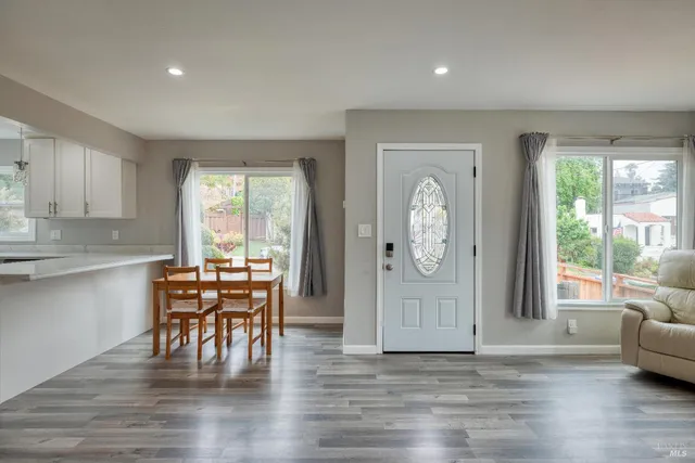 a view of dining room with furniture window and wooden floor