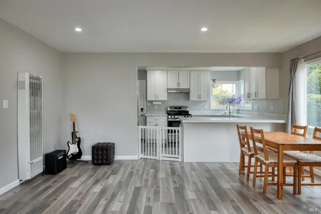 a kitchen with granite countertop a stove sink and cabinets