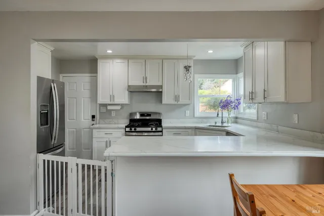 a kitchen with a sink stove and cabinets