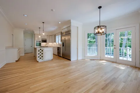 a view of a kitchen with a stove wooden floor and a kitchen