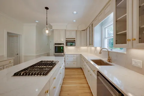a kitchen with a sink stove and cabinets