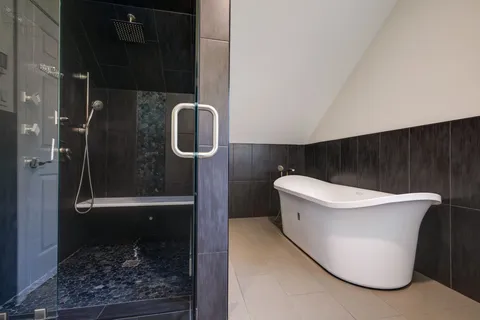 an empty room with windows and chandelier fan