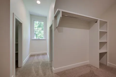 a view of a livingroom with a ceiling fan and window