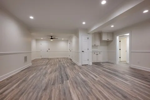 a view of backyard with large trees and wooden floor