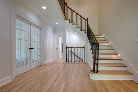 a view of a hallway with wooden floor and entryway