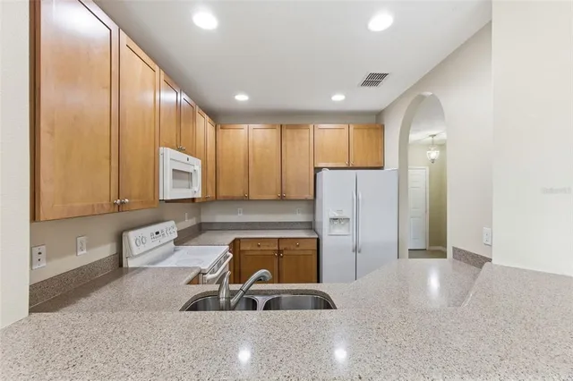 a view of empty room with wooden floor and ceiling fan