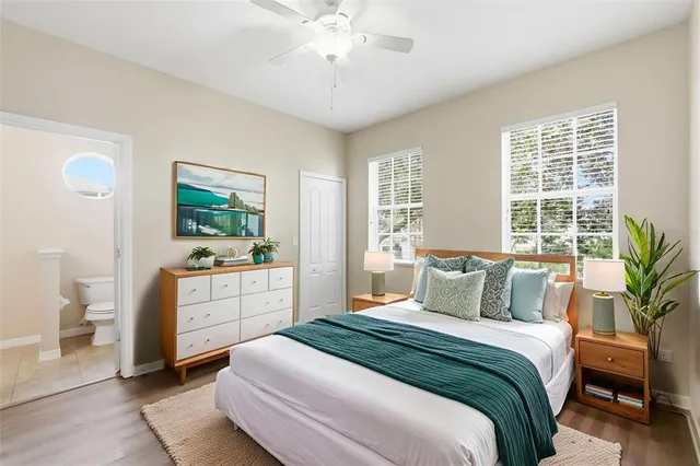 a view of an empty room with wooden floor and windows