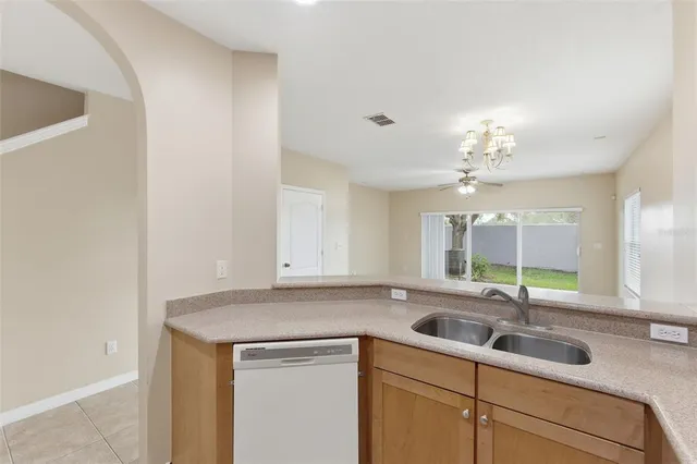 a kitchen with a sink stove top oven and cabinets