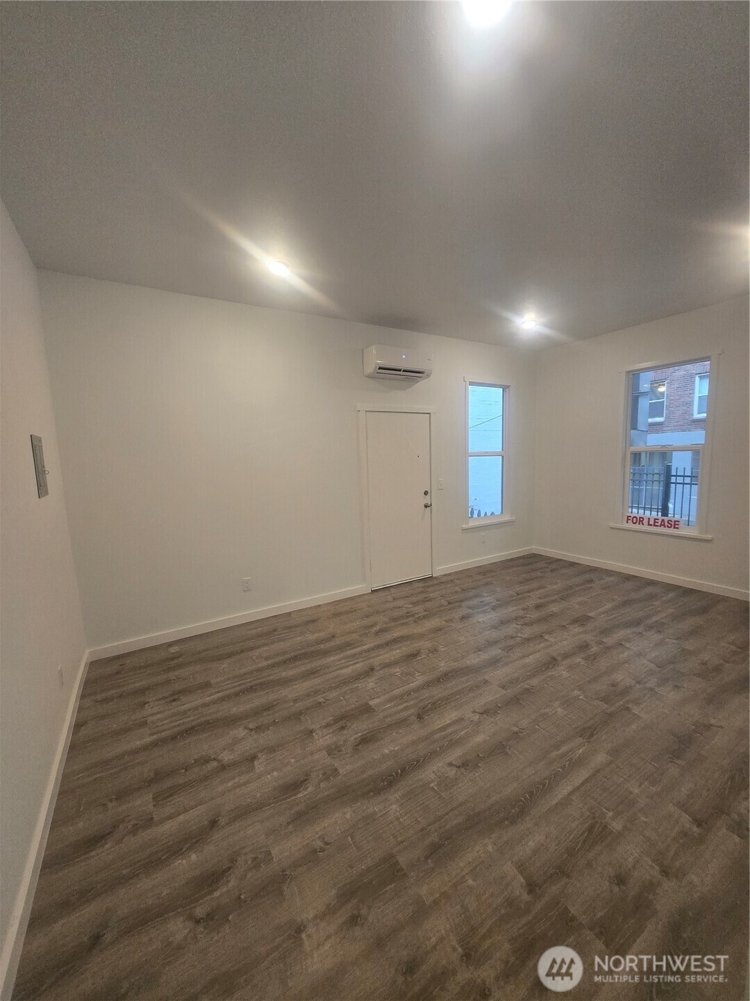 4332 University Way Northeast, Unit A Seattle, WA 98105 - Photo 4 of 20 an empty room with wooden floor and windows