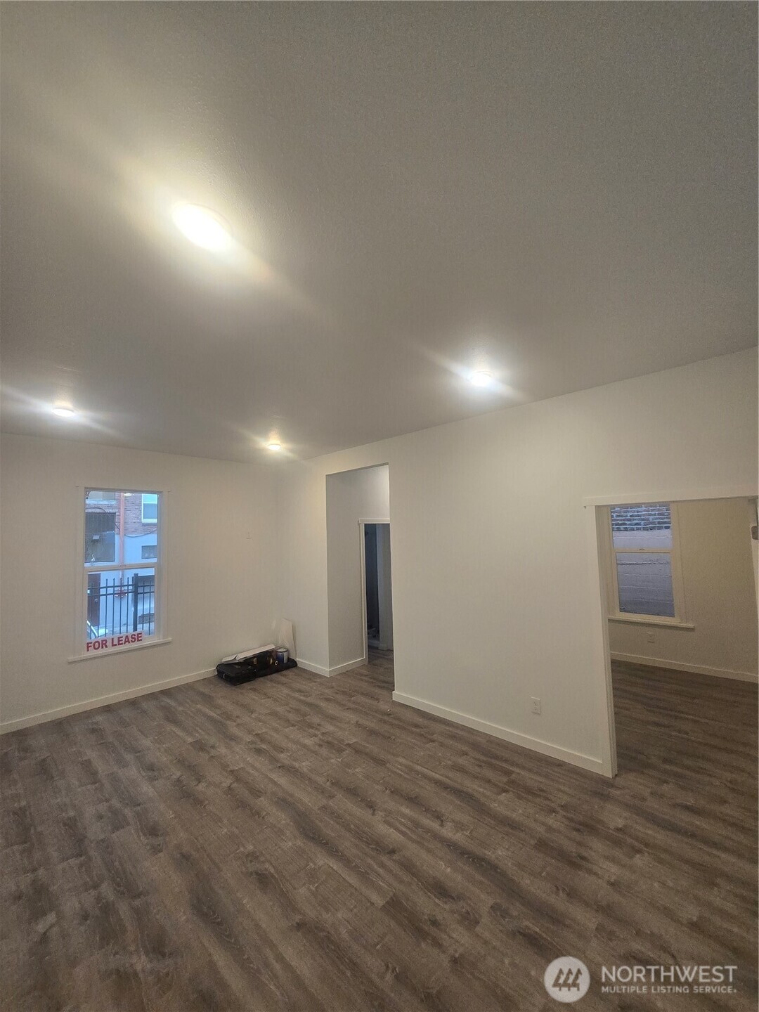 4332 University Way Northeast, Unit A Seattle, WA 98105 - Photo 5 of 20 an empty room with wooden floor and windows