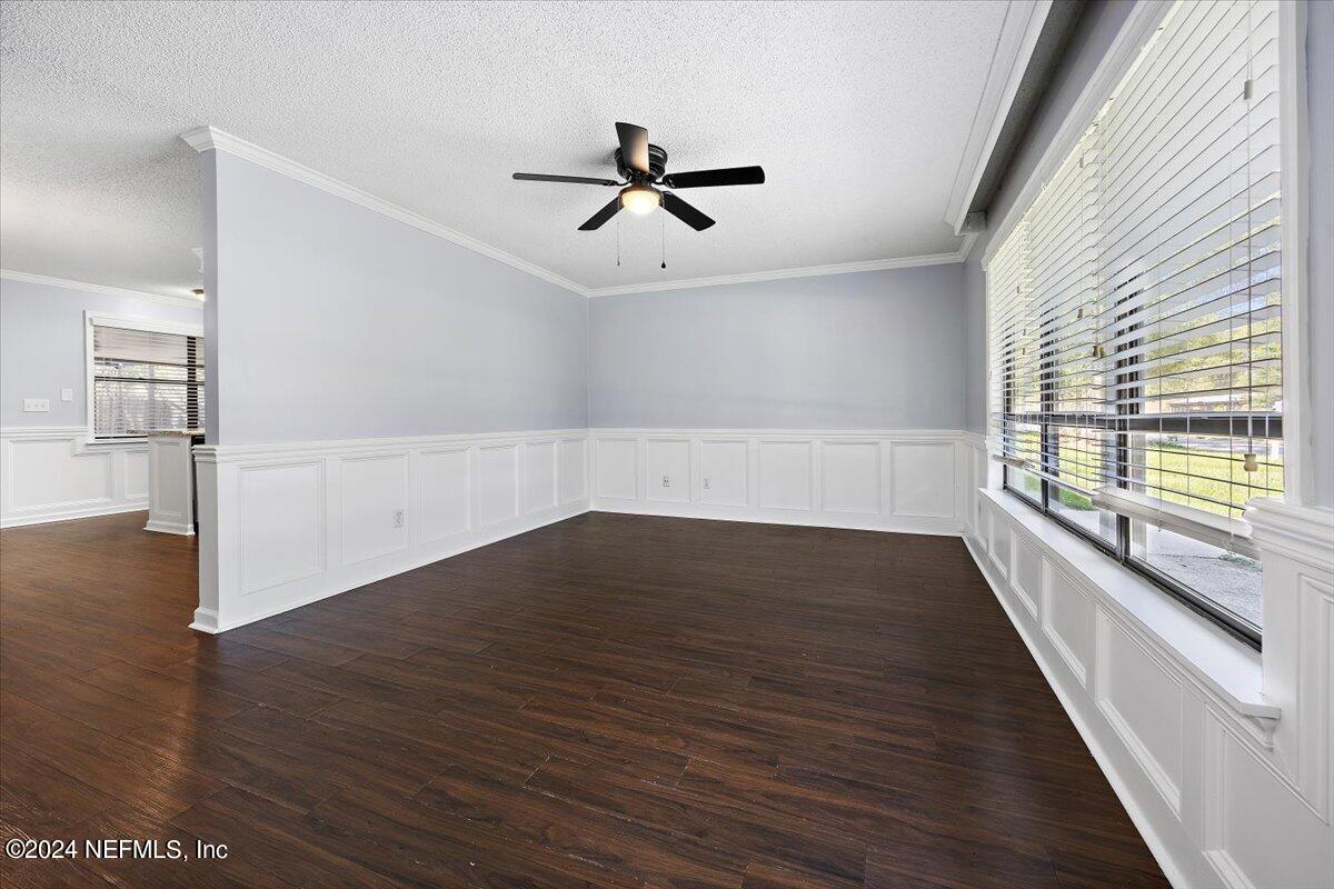 3176 Ricky Drive Jacksonville, FL 32223 - Photo 3 of 22 wooden floor in an empty room with a window
