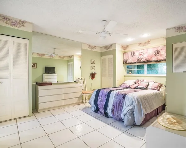 a large bedroom with a large bed and a window