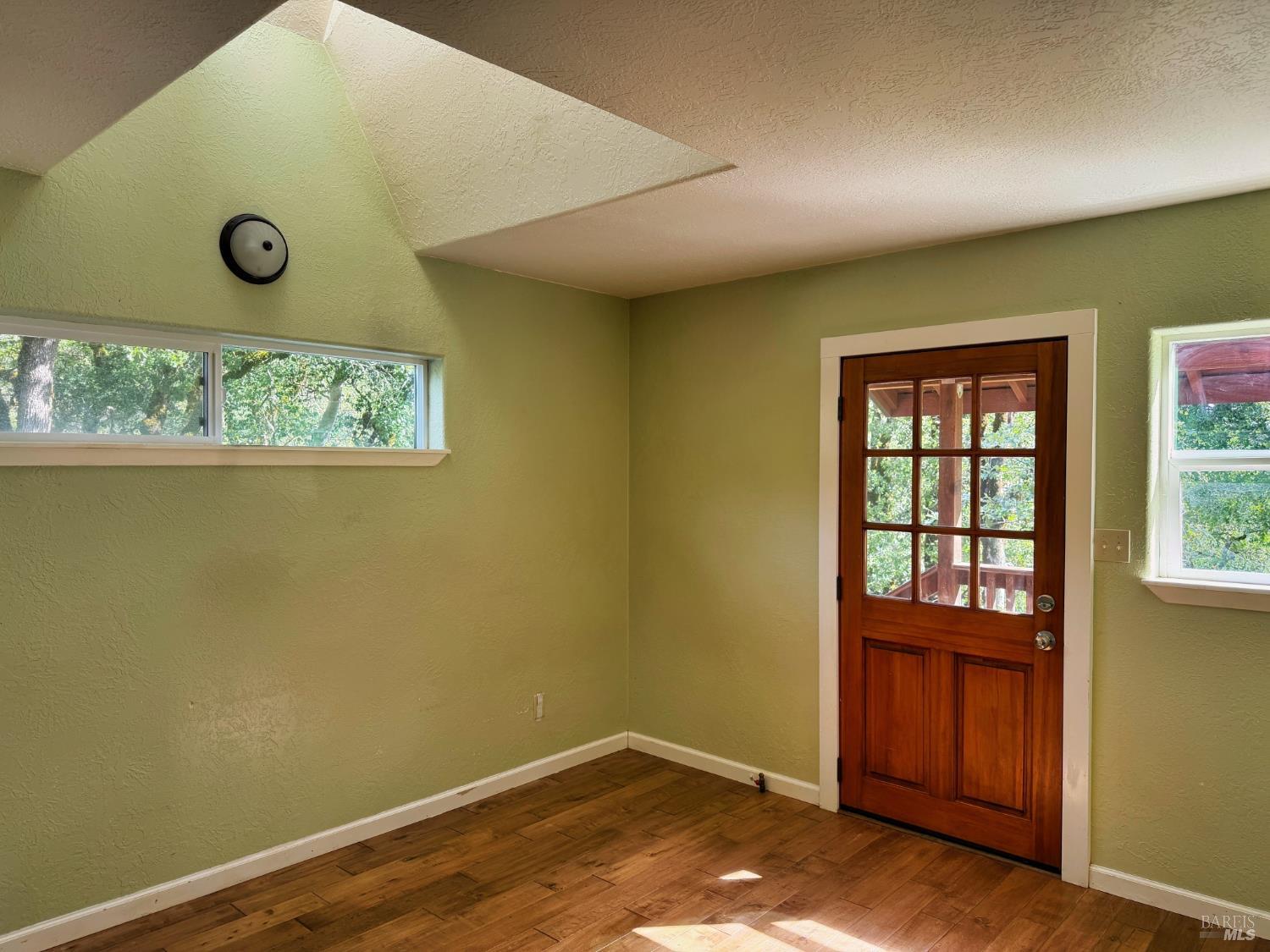 2501 Main Ranch Road Redwood Valley, CA 95470 - Photo 5 of 57 a view of an empty room with a window and wooden floor