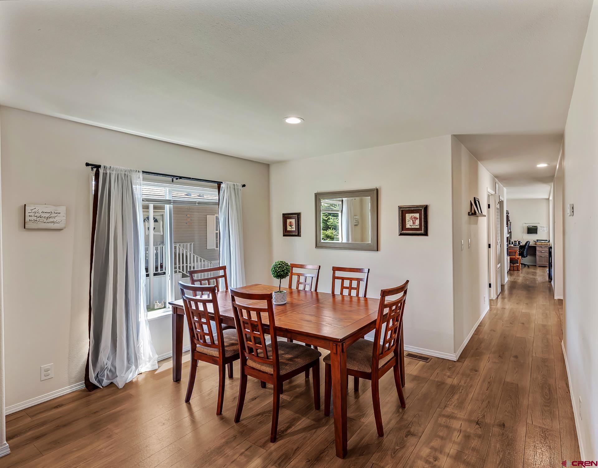 901 6530 Road, Unit 3007 Montrose, CO 81401 - Photo 13 of 33 a view of a dining room with furniture and wooden floor