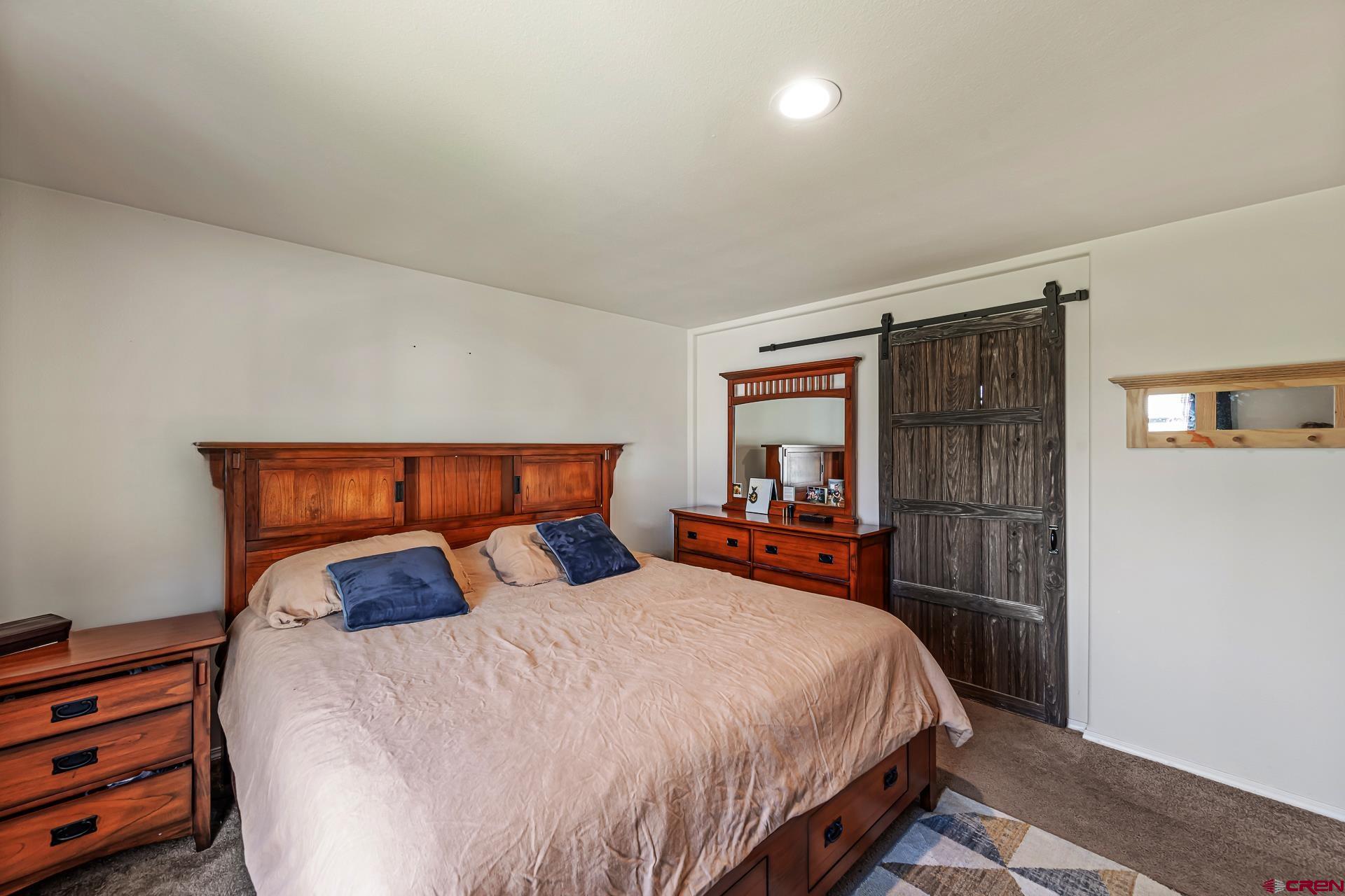 901 6530 Road, Unit 3007 Montrose, CO 81401 - Photo 14 of 33 a bed sitting in a bedroom next to a window