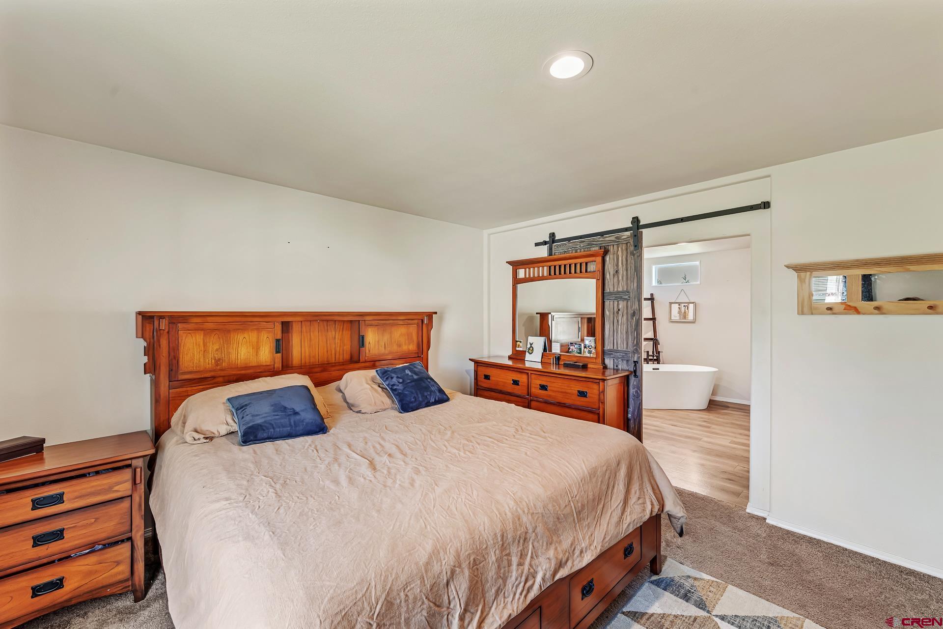 901 6530 Road, Unit 3007 Montrose, CO 81401 - Photo 15 of 33 a bed sitting in a bedroom next to a window