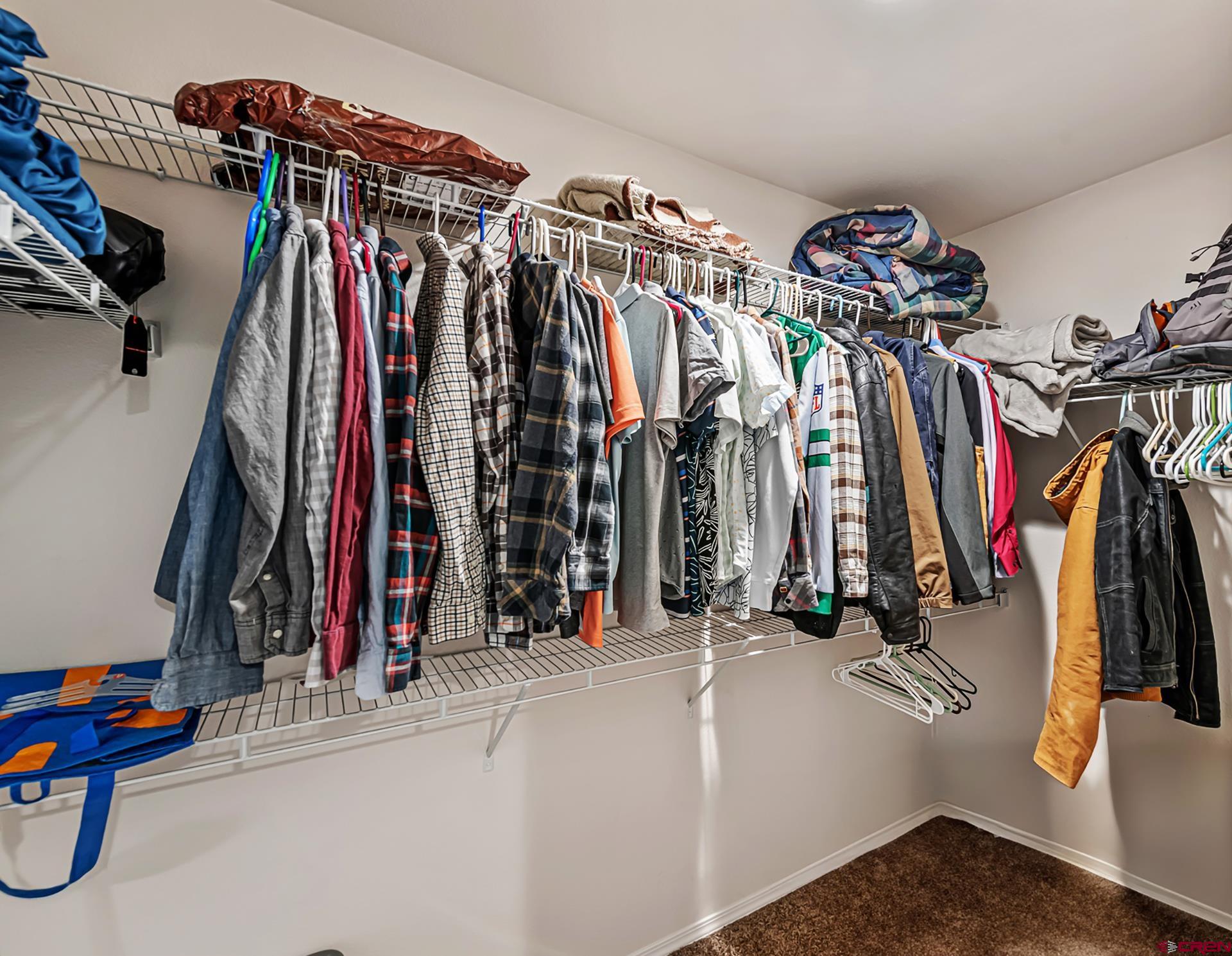 901 6530 Road, Unit 3007 Montrose, CO 81401 - Photo 17 of 33 a view of walk in closet with clothes