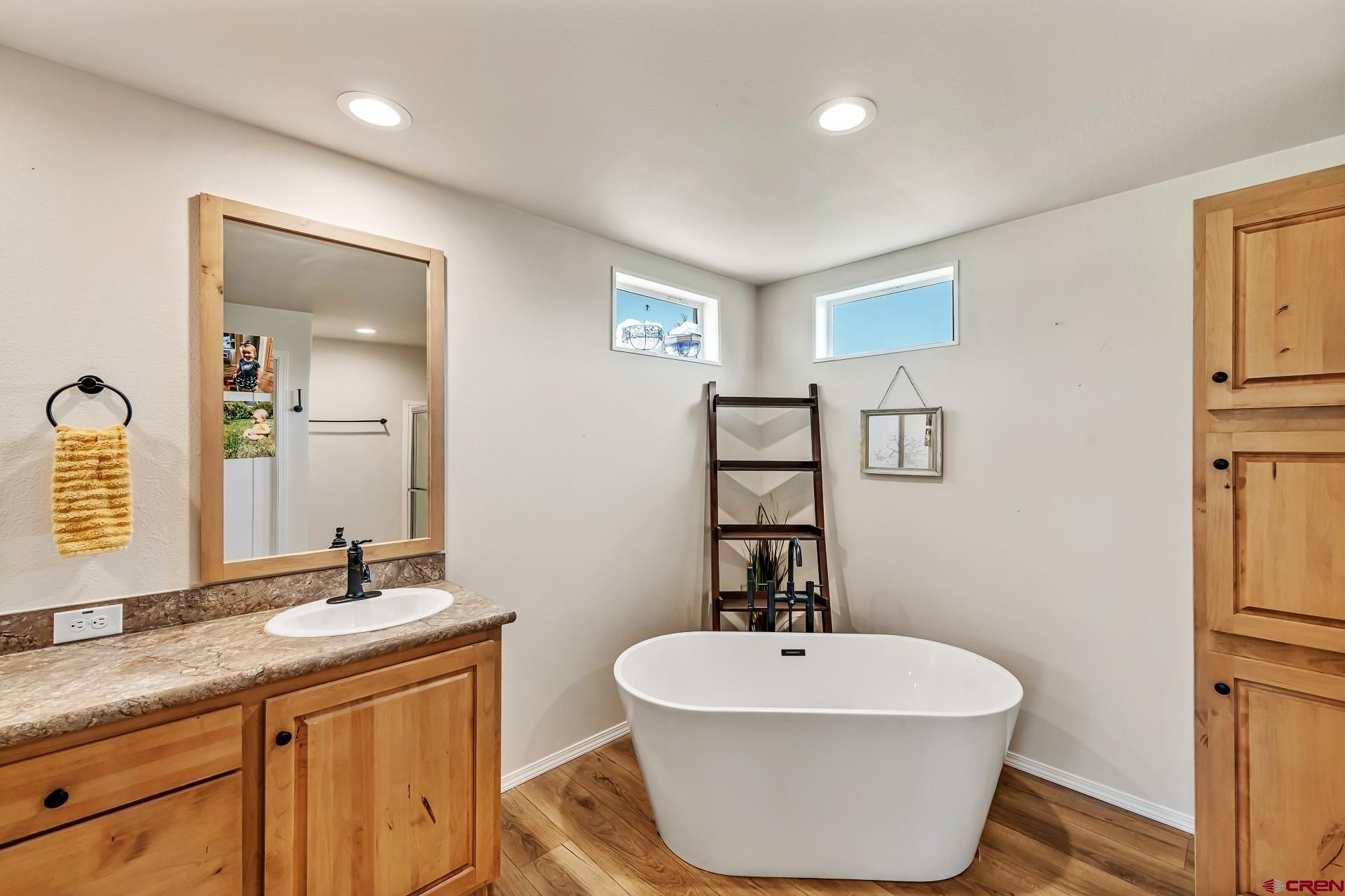 901 6530 Road, Unit 3007 Montrose, CO 81401 - Photo 19 of 33 a bathroom with a toilet sink and mirror