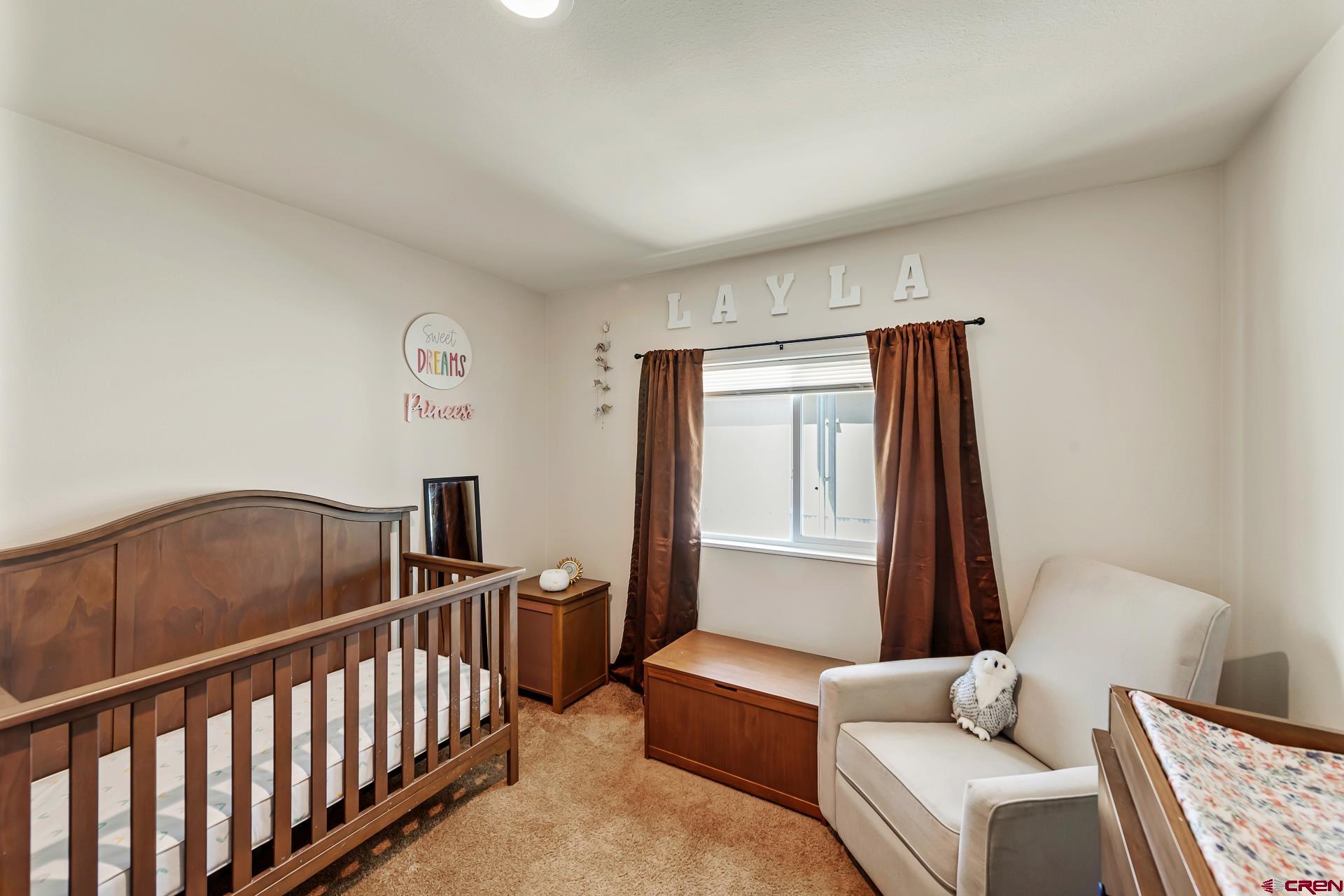 901 6530 Road, Unit 3007 Montrose, CO 81401 - Photo 20 of 33 a bedroom with furniture and a window