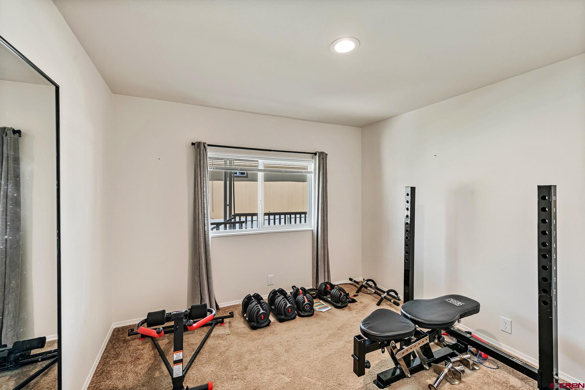 901 6530 Road, Unit 3007 Montrose, CO 81401 - Photo 22 of 33 a room with gym equipment and a large window
