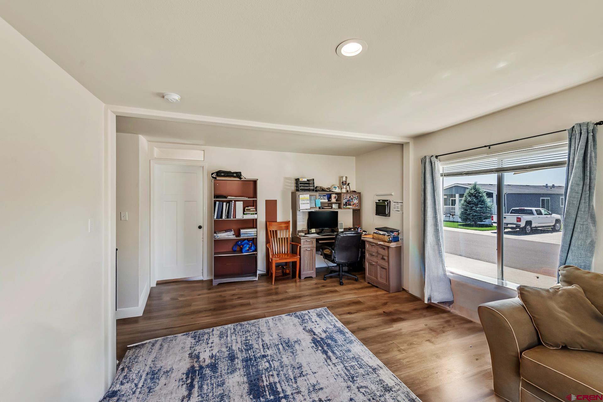 901 6530 Road, Unit 3007 Montrose, CO 81401 - Photo 27 of 33 a living room with furniture and a wooden floor