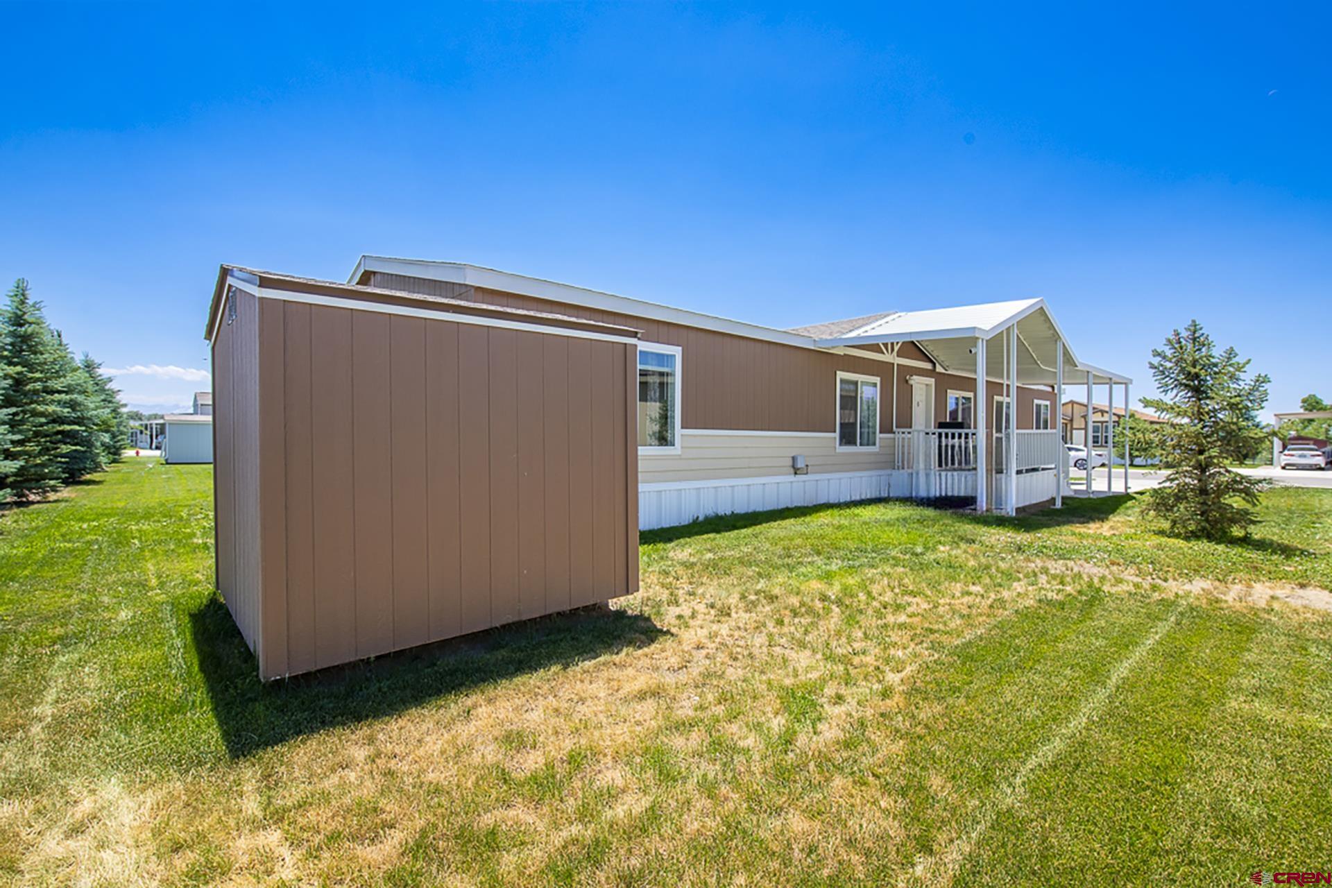 901 6530 Road, Unit 3007 Montrose, CO 81401 - Photo 31 of 33 a view of a house with backyard and sitting area