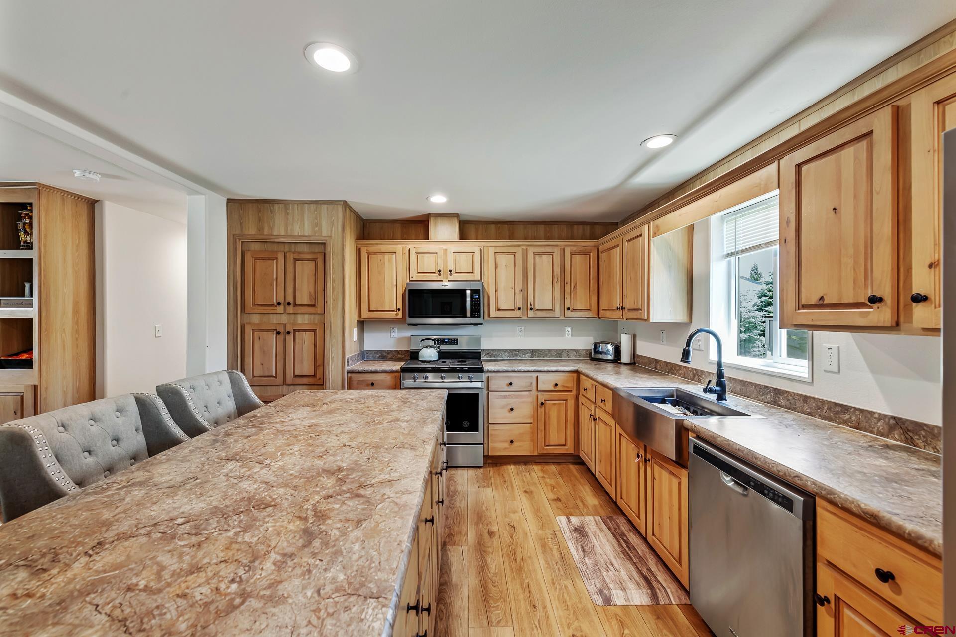 901 6530 Road, Unit 3007 Montrose, CO 81401 - Photo 9 of 33 a large kitchen with stainless steel appliances granite countertop a lot of counter space and a sink