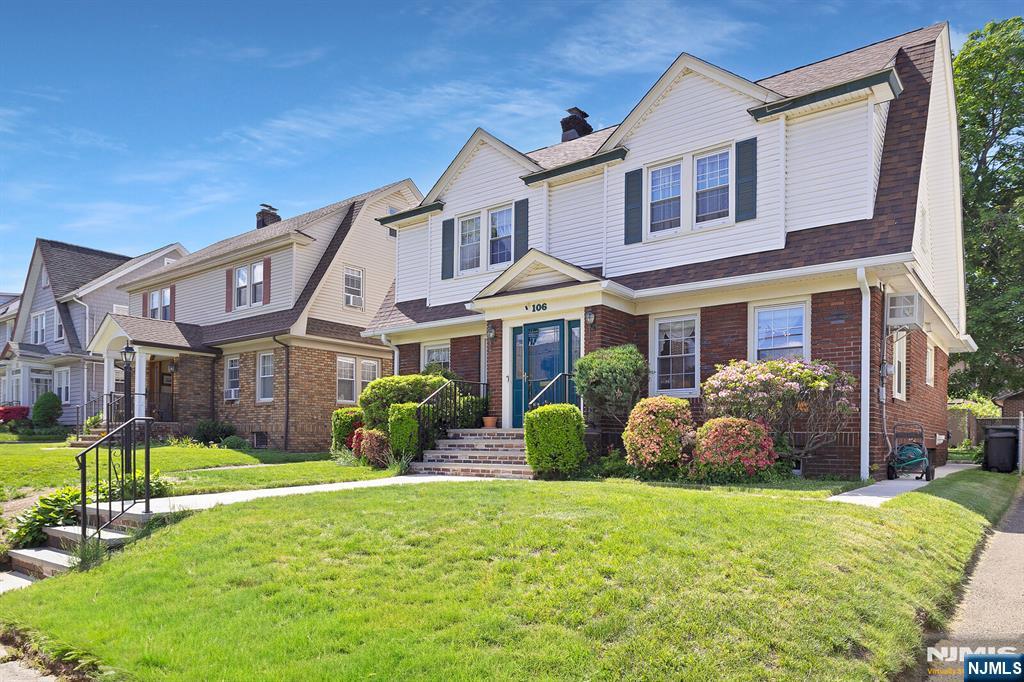 106 Maple Street Rutherford, NJ 07070 - Photo 3 of 50 a front view of a house with garden